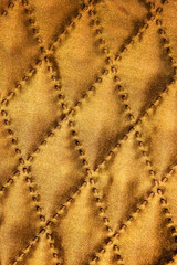 Fototapeta premium Quilted Golden Fabric With Diamond Stitching