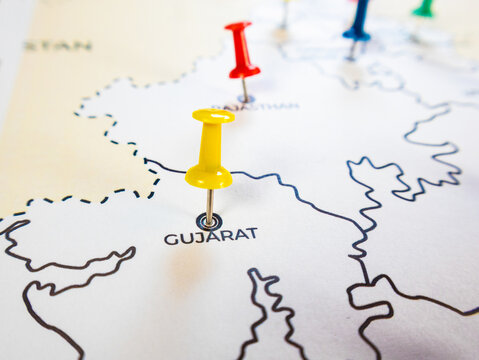 A white paper map of western India features location markers. A yellow pin marks Gujarat and a red pin marks Rajasthan, representing regional logistics, strategy targets, or travel routes.