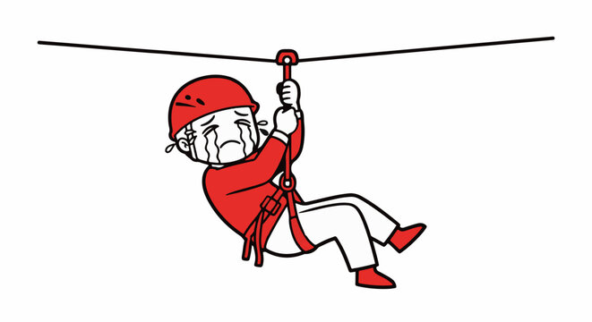 Person zip lining with safety harness and helmet outdoors.