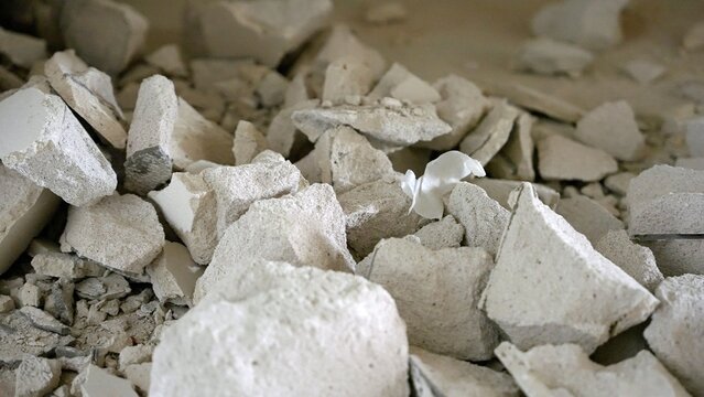 Pile of shattered plasterboard and rubble from construction site. Abstract texture background
