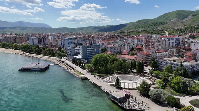 Pogradec city at the center with odeon square view and ohrid coast lake aerial view 