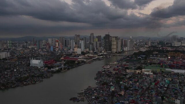 Dramatic storm clouds moving over manila cityscape and pasig river