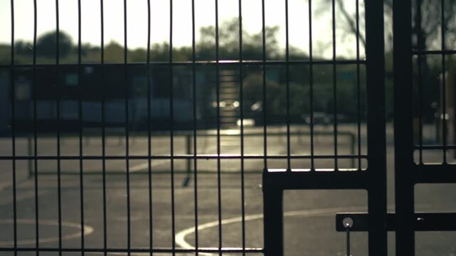 School gates with playground at dusk 