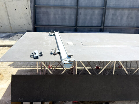 View of a large format ceramic tile being prepared with a professional rail cutter on a metal workbench at a construction site Sariyer, Istanbul, Turkiye.