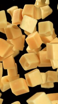 Maasdam cheese flies up and falls down on a black background. Filmed on a high-speed camera at 1000 fps. High quality FullHD footage