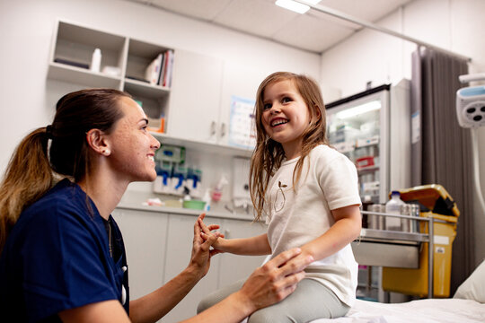 Healthcare professional engaging warmly with a child in a clinic