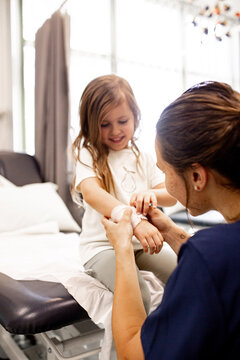 Child receiving care from healthcare professional in clinic