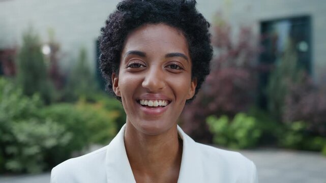 Emotional excited African American business woman laughing hearing funny humorous news in city ethnic businesswoman female girl laugh smiling with excitement happy manager smile optimistic laughter