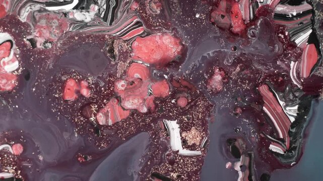 Cinematic top-down shot of deep red and black alcohol ink creating marbled textures resembling an exploding star or cosmic dust.