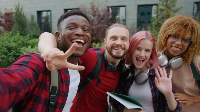 Web cam view four multiracial university students happy smiling cuddle posing looking at camera in city group of diversity friends diversity buddies smile cuddling together outdoors for selfie photo