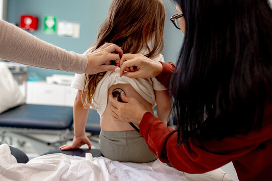 Doctor listening to child&rsquo;s breathing in clinic