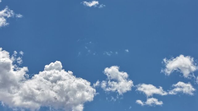 4K steady timelapse captures the final moments of a cloud evaporating into the atmosphere. Cinematic meteorological motion reveals a fragmented cloud dissolving against a clear blue desert sky.