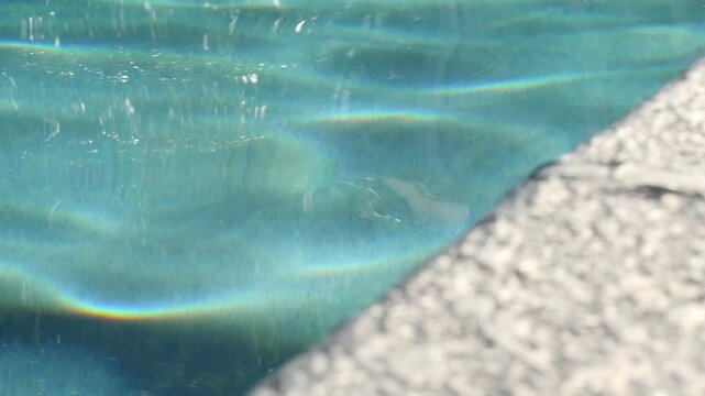 Clear blue pool water rippling, shot in 120 frames per second, 1080p for ultra slow motion.
