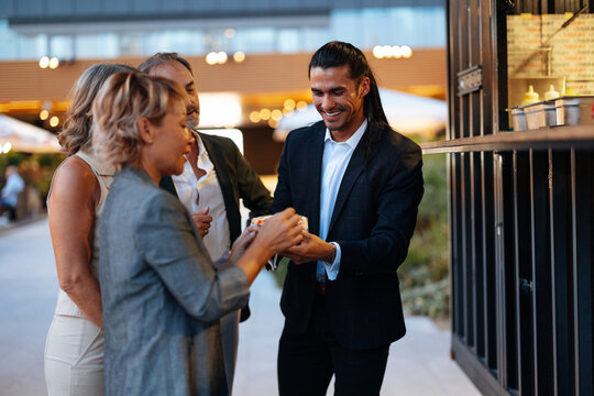 Business people receiving street food from vendor