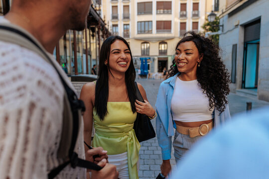 Diverse friends walking, laughing, and enjoying city life