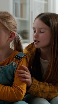 Caucasian family sisters quarrel misunderstanding little cute upset child girl offended ignoring avoid older sister talking calming supporting asking for forgiveness children kids conflict at home