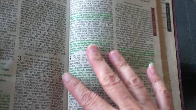 April 24th 2026: Holy Bible open up to the book of 2 Timothy of the new testament, zooming into Chapter 3 verse 16 on the power of scripture. New Revised Standard Version.