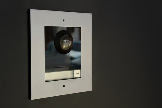 Modern video intercom system with speaker and access button indoors