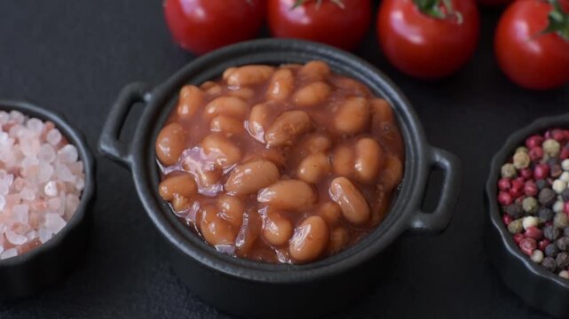 Beans in tomato sauce, a canned stew for the dinner table. Beans in tomato sauce as a food background for your design
