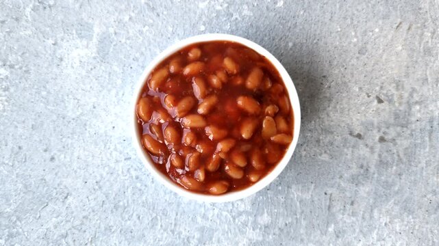 Beans in tomato sauce, a canned stew for the dinner table. Beans in tomato sauce as a food background for your design