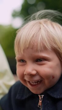 Happy kid at park. Infant giggling during cheerful family picnic