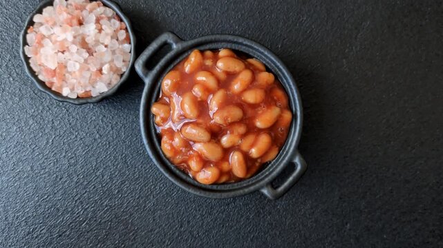 Beans in tomato sauce, a canned stew for the dinner table. Beans in tomato sauce as a food background for your design