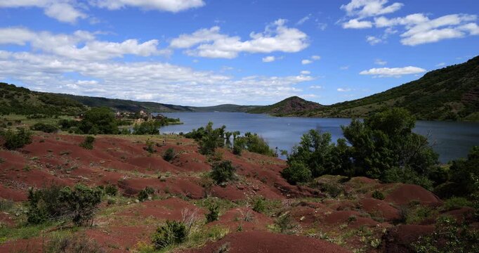 Red landscape surrounding te artificial lake of Salagou, Occitania, Southern France.