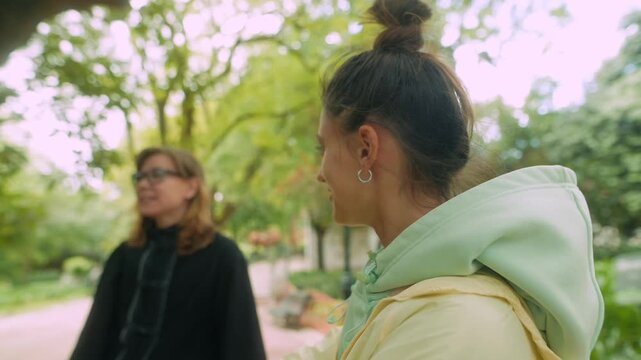 Young lady converses kindly with her mentor outdoors in daylight