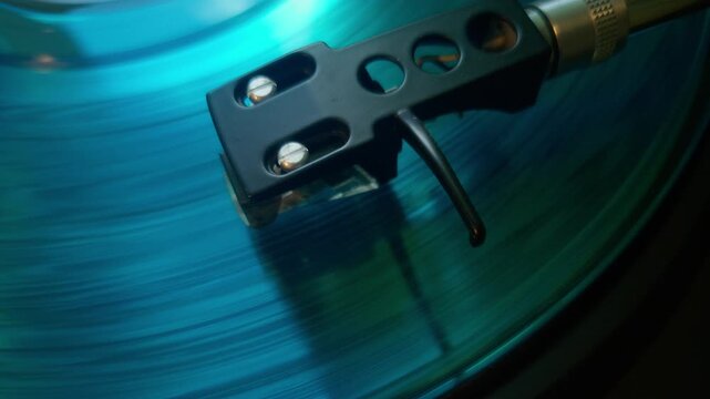 Vinyl record playing on turntable with stylus close-up