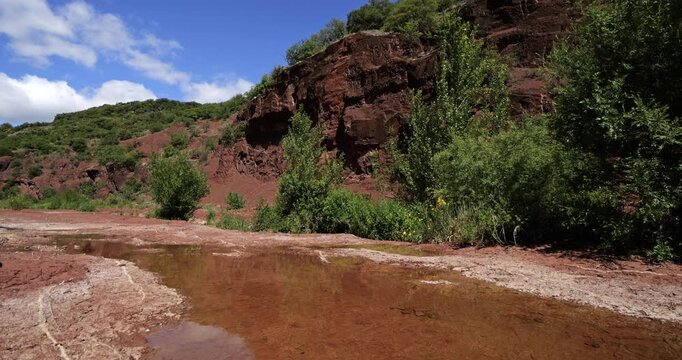 Red landscape surrounding the artificial lake of Salagou, Occitania, Southern France.