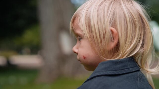Little kid walks through park with wonder and gentle breeze