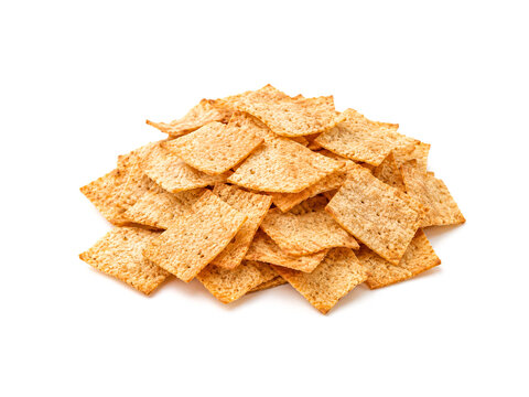 Pile of crunchy crispy square crackers isolated on white background..