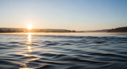 Obraz premium Calm Lake Water at Sunrise with Golden Reflection