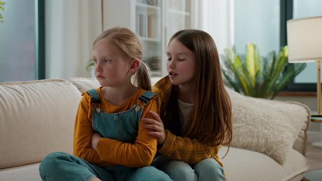 Caucasian family sisters quarrel misunderstanding little cute upset child girl offended ignoring avoid older sister talking calming supporting asking for forgiveness children kids conflict at home