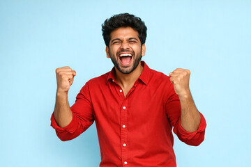Fototapeta premium Happy Indian man in red shirt smiling and cheering