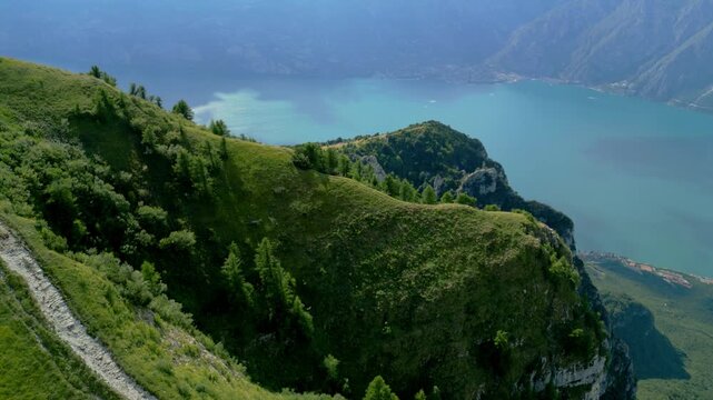 Aerial view glides over Monte Baldo ridge with Lake Garda and Limone Sul Garda beyond