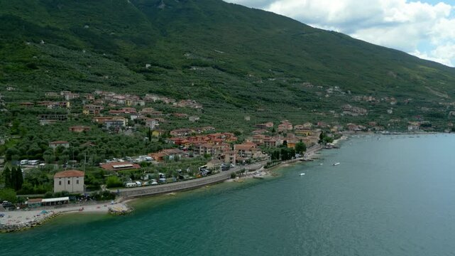 Aerial view of Malcesine town along Lake Garda shoreline with Monte Baldo backdrop