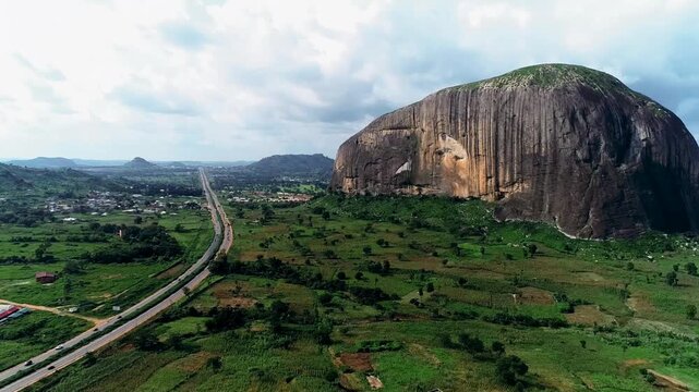 A majestic natural rock formation standing as a national landmark between Abuja and Niger State symbolizing strength beauty and cultural heritage