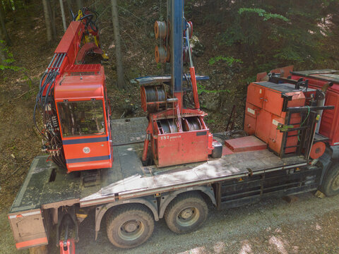 Aerial view of a truck mounted tower yarder near Dolny Jelenec with cables and machinery parked on a forest road in Stare Hory, Banskobystricky kraj, Slovakia.