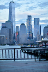 Obraz premium Tranquil Waterside Cafe Scene During Sunset With Scenic Skyline And Umbrellas new york