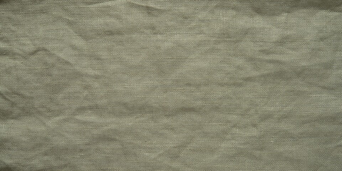 Fototapeta premium Olive green linen fabric texture, crumpled dark cotton cloth background with wrinkled pattern.