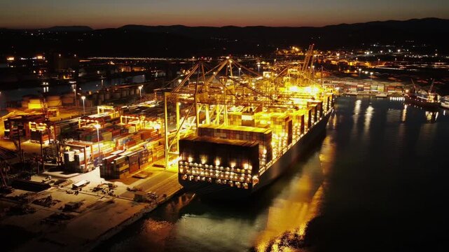 Pre dawn port timelapse with illuminated container ship