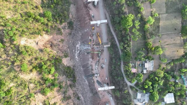 Infrastructure development: New highway cutting through mountains. Video focusing on regional progress, national connectivity, and transportation expansion in Rural India.