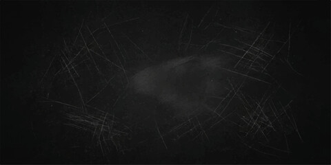 A textured blackboard with faint chalk dust and numerous scratches, creating a rustic and vintage backdrop for creative expression or educational content. © PS  GALLERY 