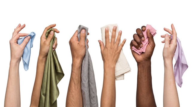 Diverse hands holding various soft, colorful cleaning cloths and fabrics isolated on a transparent background.