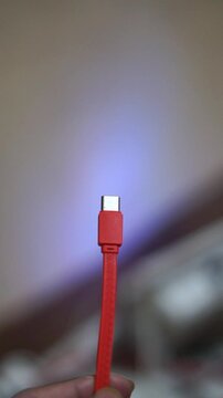 Red USB Type-C charging cable with a modern design for electronic devices and smartphones.	