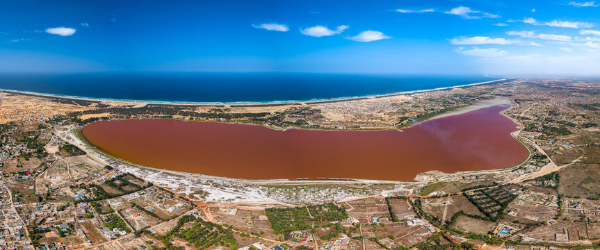 Aerial view of Lake Retba with its pink water and white salt banks near the Atlantic coast in Rufisque, Dakar Region, Senegal.