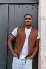 Fototapeta premium African man standing outdoors in vest and jeans