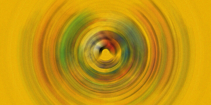 Abstract circular motion background with yellow radial pattern and grain effect representing energy or swirling vortex waves.