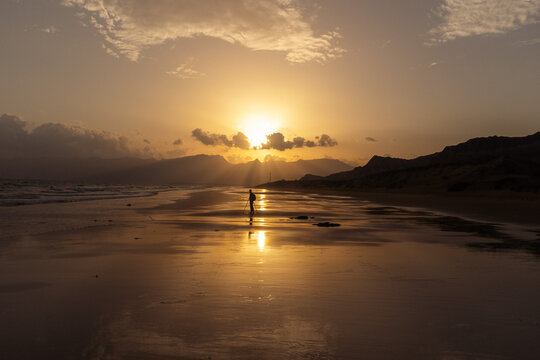 Balochistan - Pakistan - April 08, 2026: A breathtaking scenery of a silhouette of a person filming the sunset view on the beach